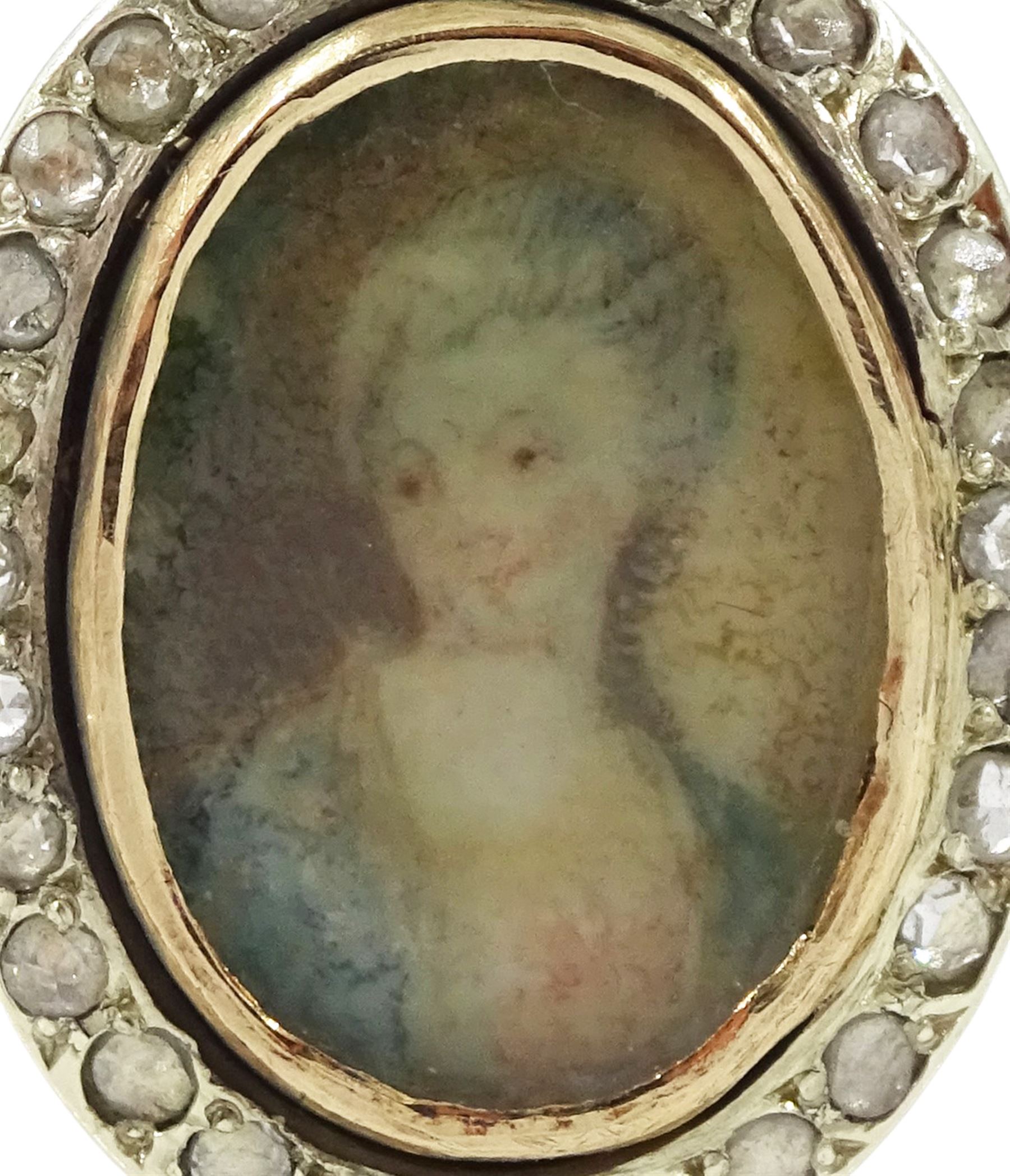 19th century 9ct gold diamond portrait ring, set with an oval miniature of a woman in 18th century dress on ivory, under a glazed panel, with rose cut diamond surround, on later shank. This lot has been registered for sale under Section 10 of the APHA Ivory Act