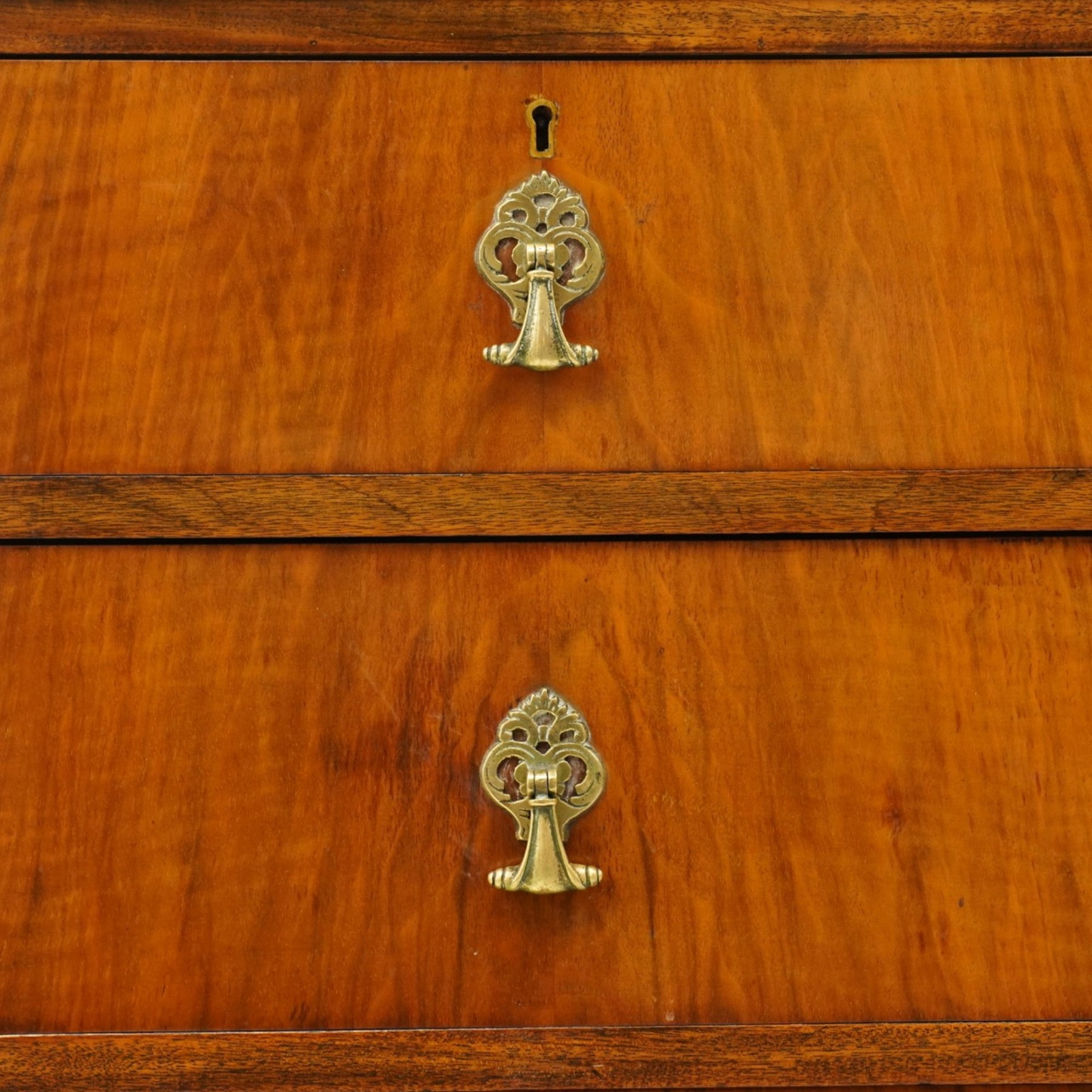 Early 20th century figured walnut chest, rectangular top with burr crossbanding, fitted with two short over three long drawers with brass drop-handles, lower moulded edge over shell-carved cabriole feet