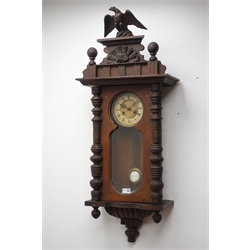  Early 20th century Vienna style wall clock with eagle cresting, circular Roman dial with twin train movement striking the hours on a coil, with key and pendulum, H106cm  