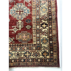 Turkish style red ground rug, repeating border, central medallion, 250cm x 160cm