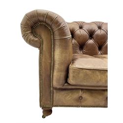 HALO - Chesterfield style four seat sofa upholstered in buttoned brown leather with stud work, on turned feet with castors