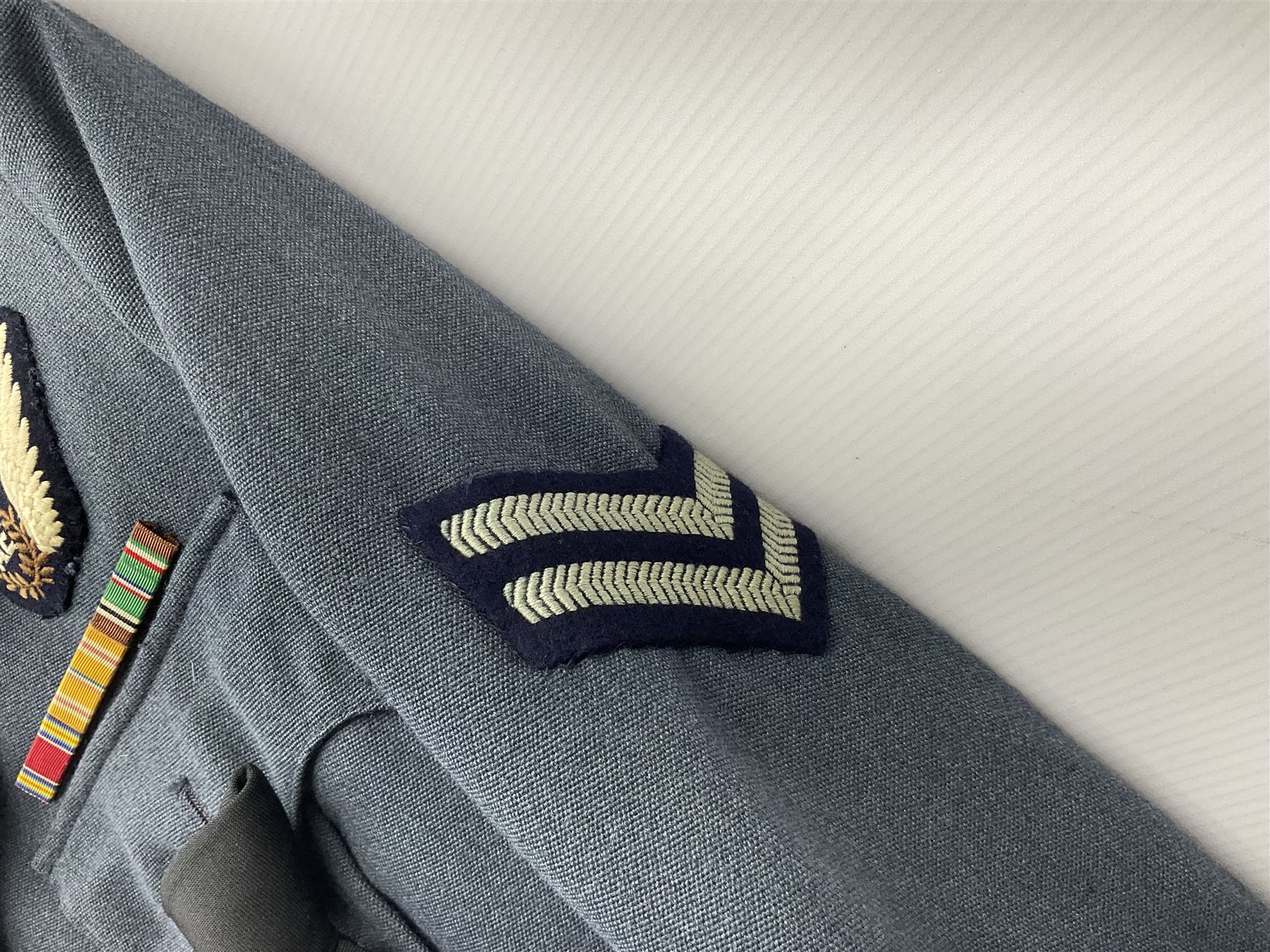 Two post-WWII British Army No.2 Dress tunics, one with Green Howards buttons; army shirt dated 1951; Royal Fleet Auxilliary jacket with trousers; three RAF/WAAF uniforms and RAF Greatcoat; and three canvas/webbing bags, two dated 1943 & 1945