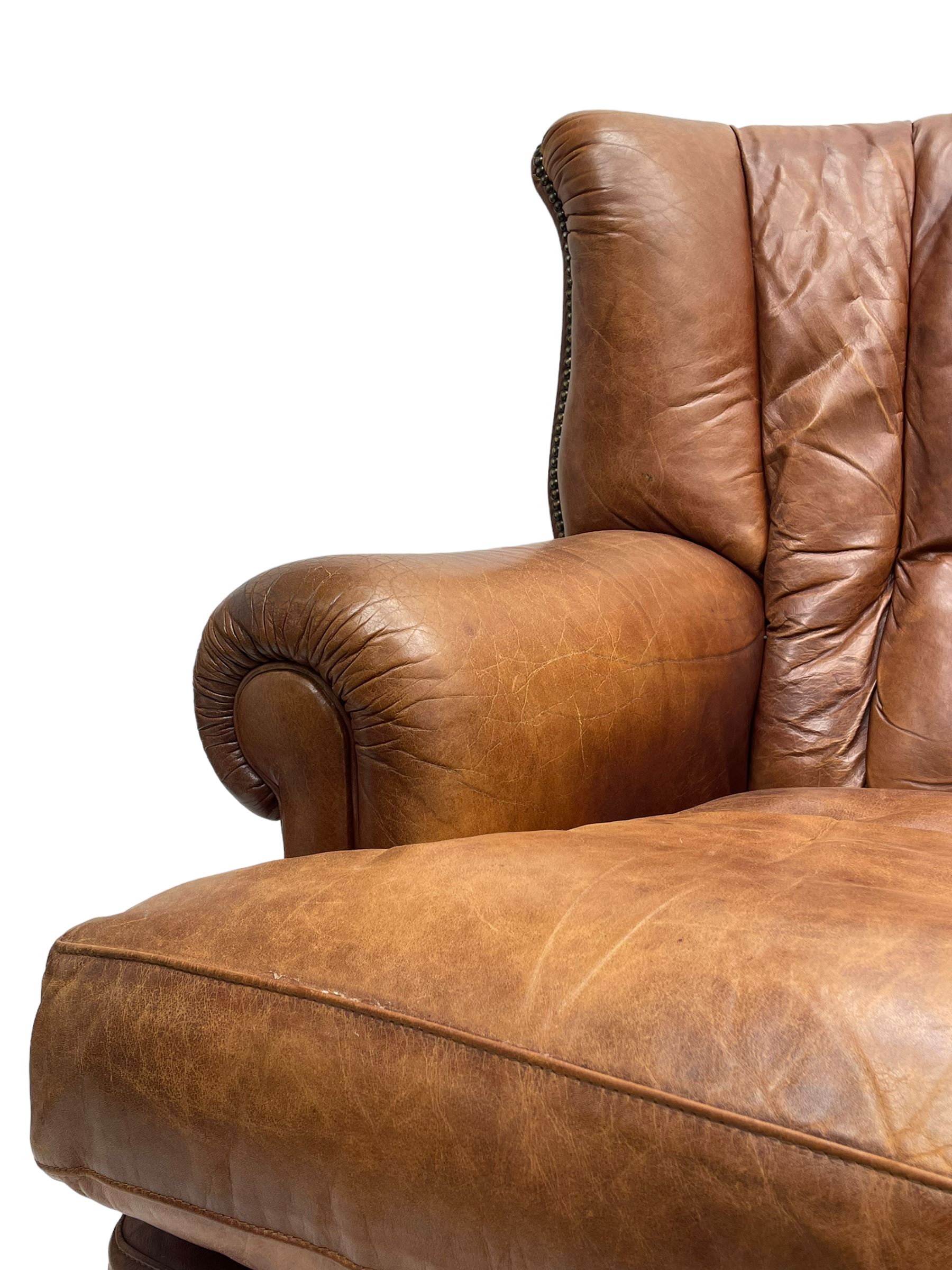 Tetrad - 'Blake' club armchair, fanned wingback and rolled arms upholstered in tan brown leather, on ball and claw carved cabriole feet 