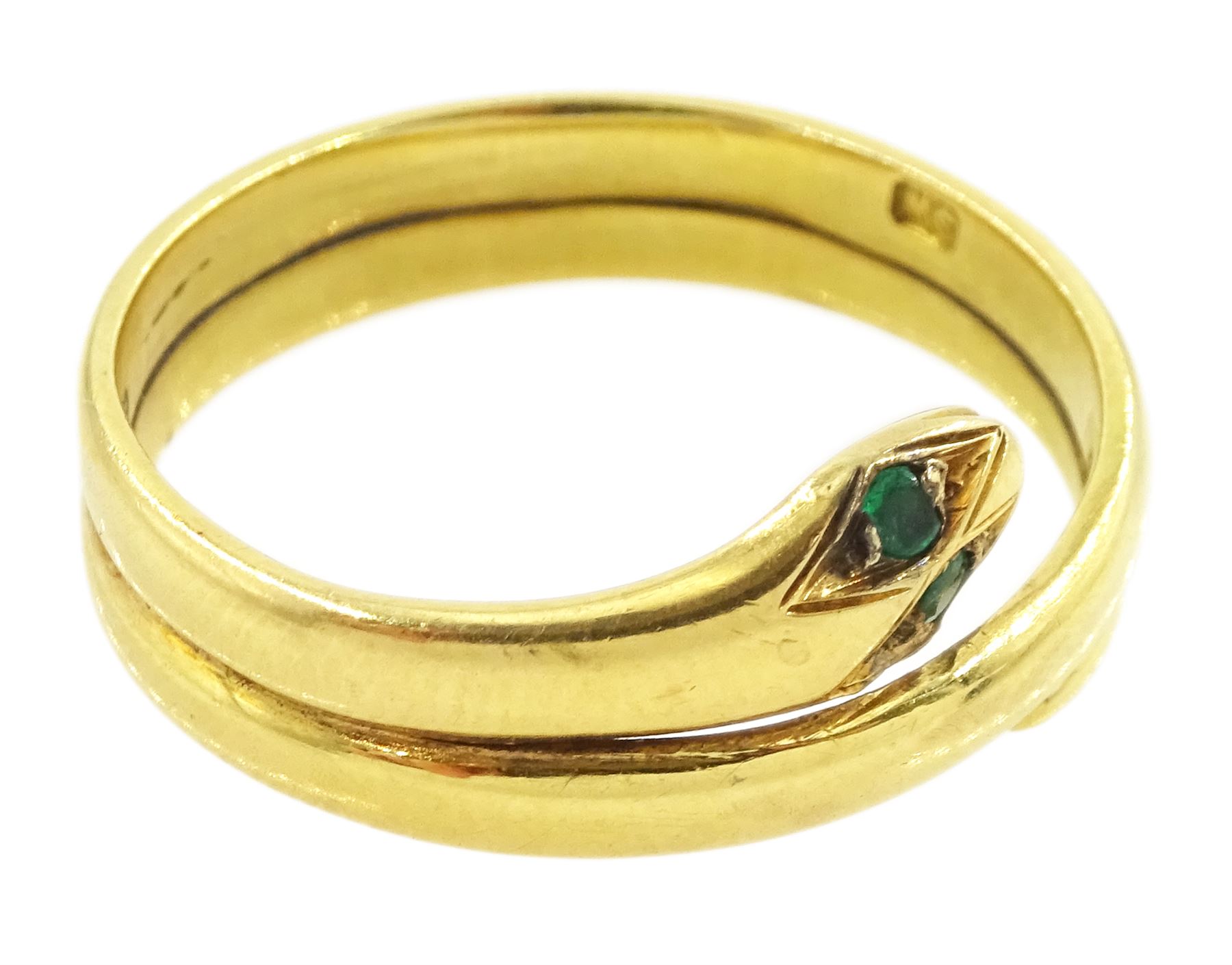 Early 20th century 18ct gold coiled snake ring, with green stone set eyes