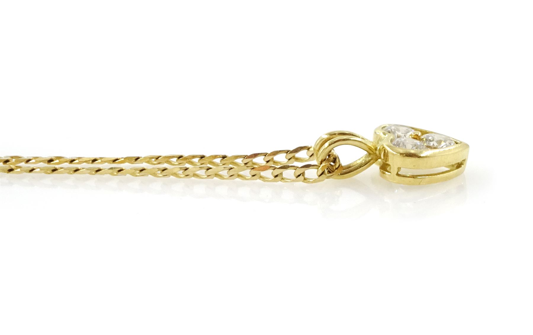 18ct gold diamond heart shaped pendant, three round brilliant cut diamonds of approx 0.55 carat, on 9ct gold flattened curb link chain necklace, both hallmarked