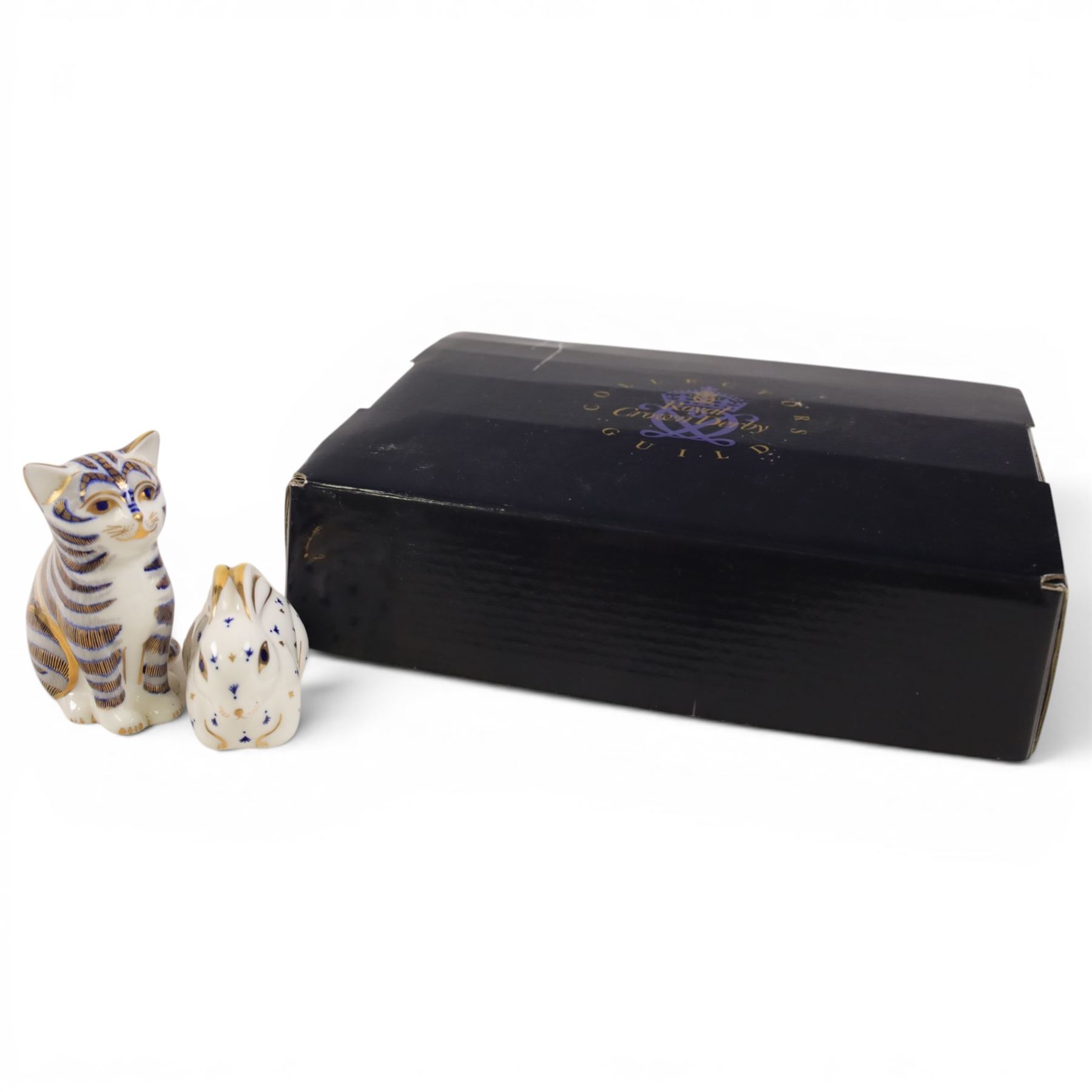 Three Royal Crown Derby paperweights, comprising Seated cat, Rabbit and Sleeping cat, all with gold stoppers 