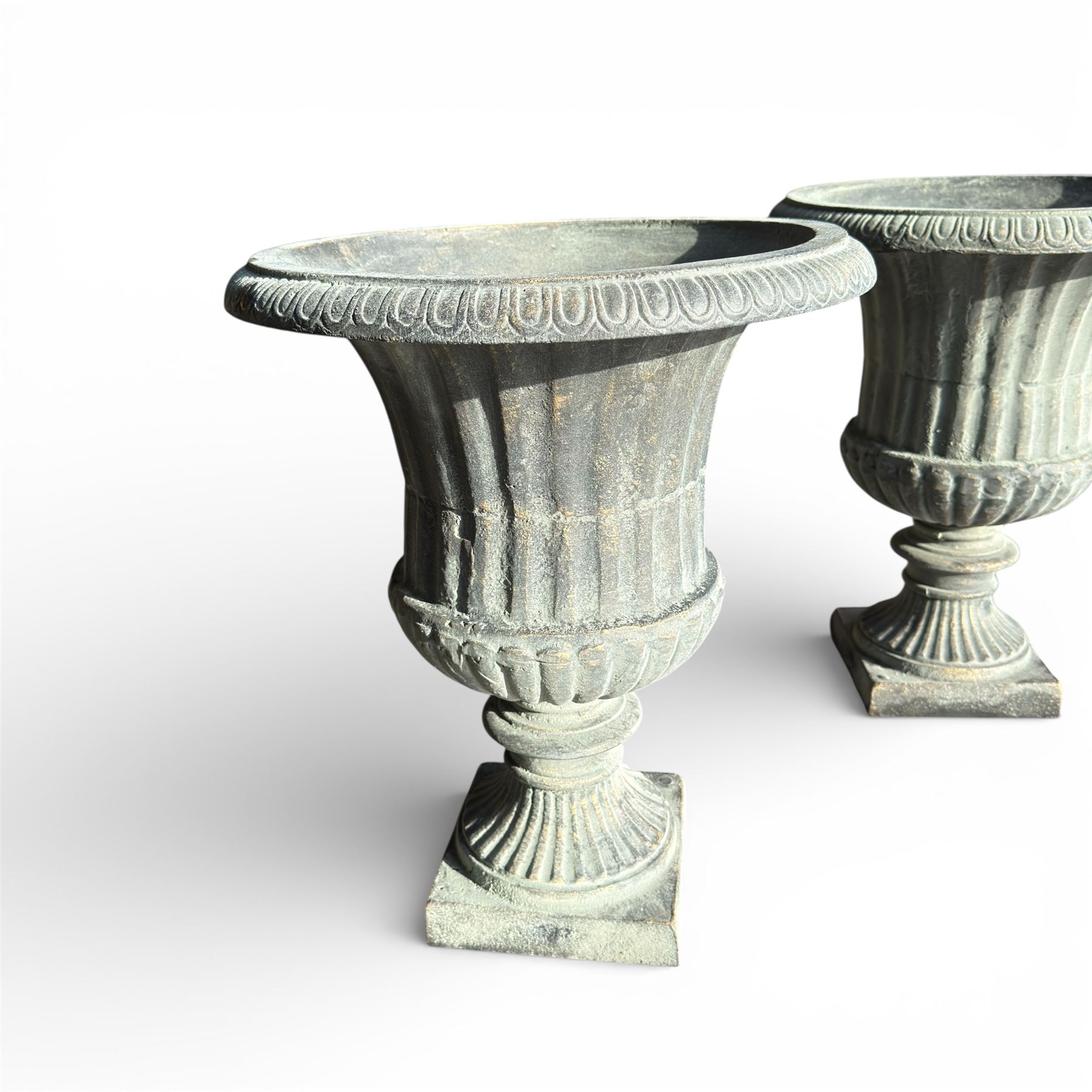 Pair of cast iron Urns on square bases