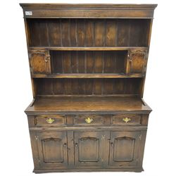 Georgian design oak dresser, the two-tier plate rack with two flanking spice cupboards, the base fitted with three drawers over three arched fielded panelled cupboards, lower moulded edge on block feet