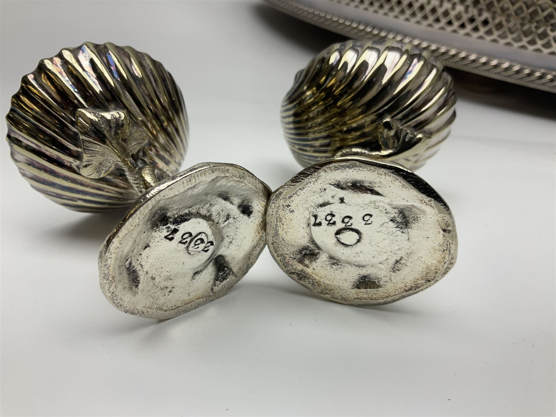 Pair of Mappin and Webb silver plate pierced pedestal bon bon dishes, together with other silver plate comprising teapot stand engraved with lion's head to centre, two cut glass claret jugs, two bottle coasters with acorn decoration, two open salts upon dolphin mounts, tea caddy, three piece cruet set and a large oval tray with pierced sides and upon four ball feet