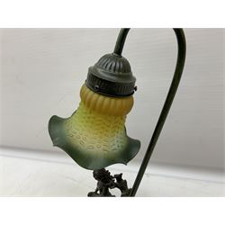 Art Deco style Widdop Bingham & Co desk lamp, modelled as boy and girl playing instruments, on naturalistic base with yellow and green frilled glass shade, with sticker label beneath, H42cm, and A Belcari figural table lamp, modelled as a young gent leaning upon brick wall, on turned wood base, signed, H70cm incl shade, together with bronzed figural table lamp of a lady with parasol upon ornate circular plinth base, two ceramic table lamps and another lamp (6)