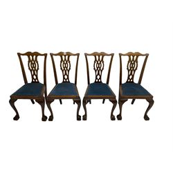 Set four George III Chippendale-style mahogany dining chairs, shaped serpentine cresting rail with pierced and splat back, drop-in seat upholstered in blue fabric, raised on cabriole supports with ball and claw feet