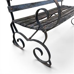 19th century wrought iron strapwork and slatted wood garden bench, the arm terminals and end supports of scrolling form