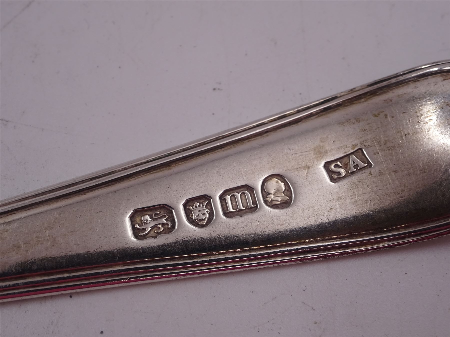 George II silver Hanoverian pattern table spoon, with rattail bowl and engraved with initials BV to terminal verso, hallmarked London 1730, makers mark IH or IK, possible Jeremiah King or John Hopkins, together with two George III silver Old English pattern table spoons, the first example with reed border, hallmarked Stephen Adams II, London 1787, the second example hallmarked London 1800, maker's mark indistinct