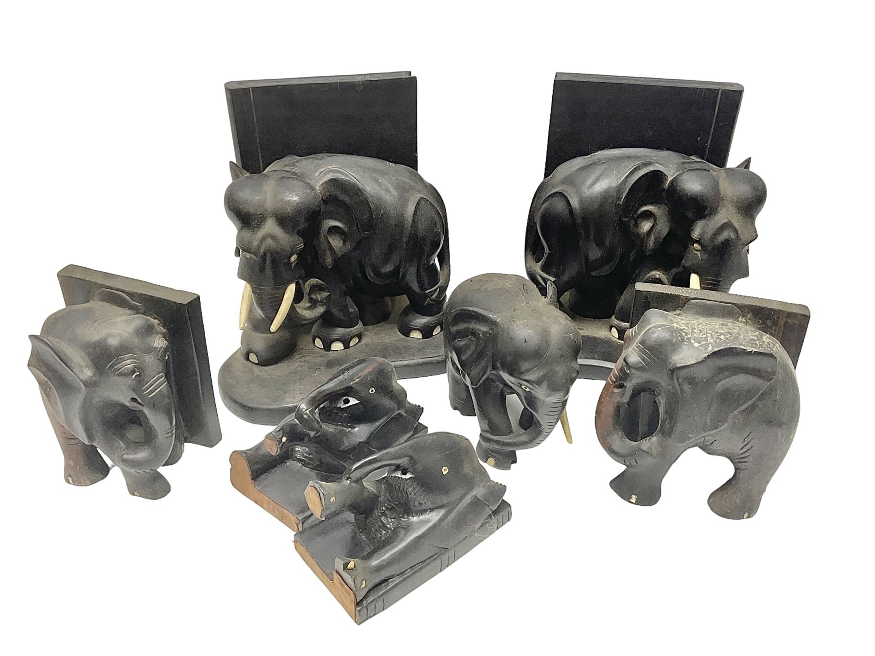 Three pairs of carved wooden elephant bookends, and a similar carved wooden elephant figure, tallest H24cm