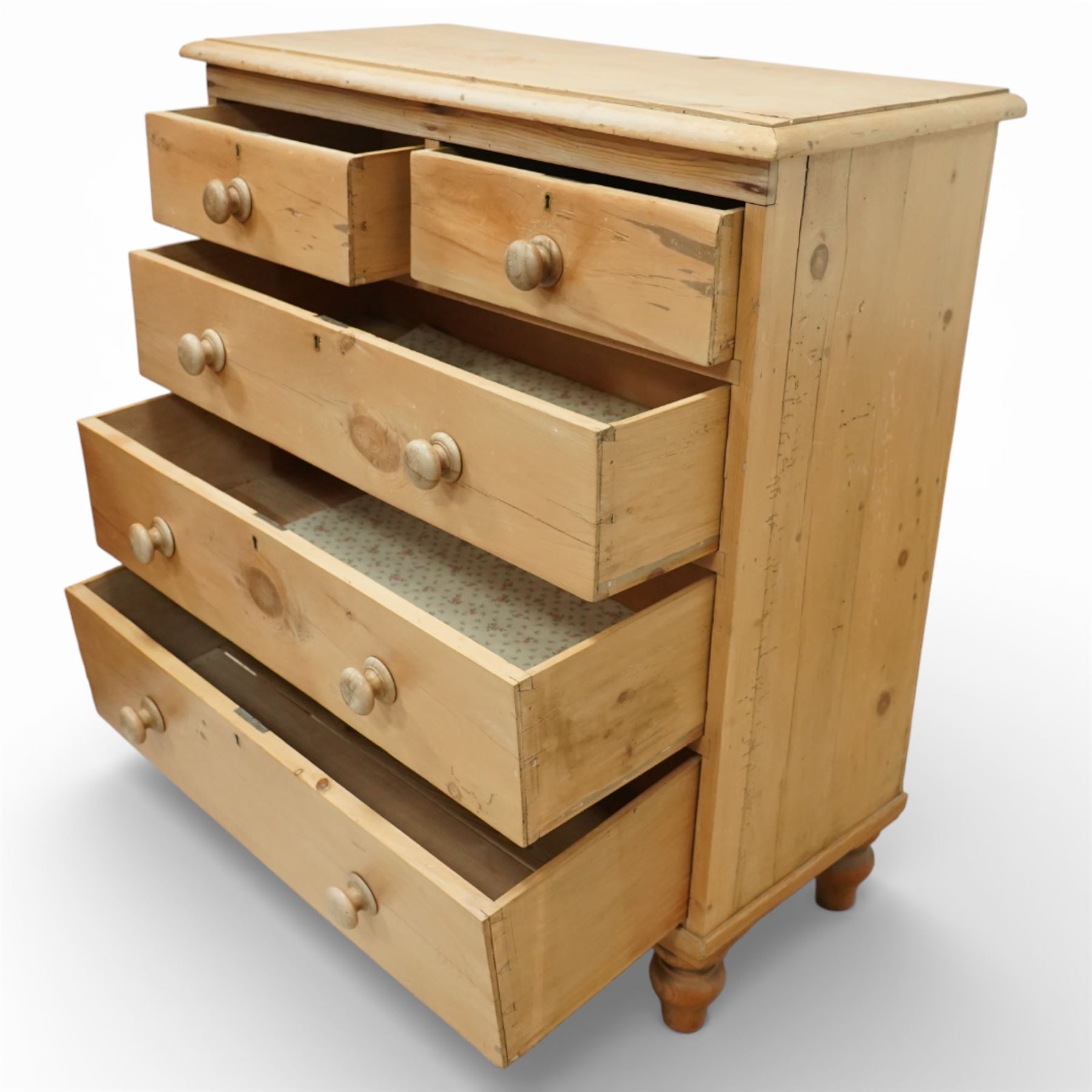 Victorian pine chest of drawers, with rounded top over two short and three long drawers fitted with turned wooden knob handles, raised on turned bun feet
