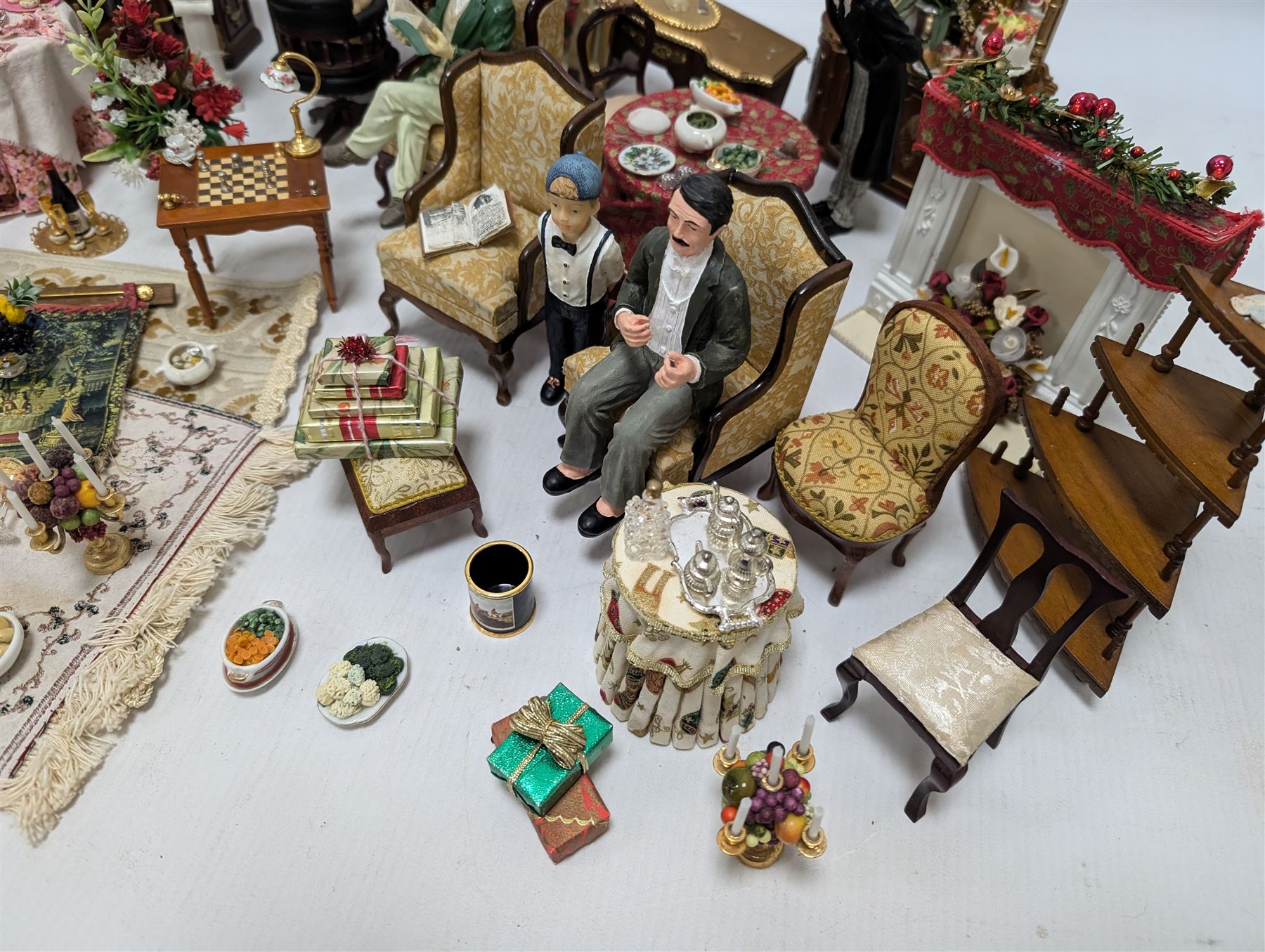 Dolls house living room and dining room furniture, including arm chairs, desk, fireplaces, dressers, tables, eight figures and a large collection of predominantly Christmas themed food, accessories and decorations