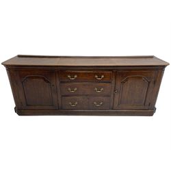 George III oak dresser base, rectangular top with rounded corners over moulded frieze rail, canted corners with turned quarter columns, fitted with three drawers with moulded edges flanked by two cupboards, enclosed by ogee arched fielded panelled doors, panelled sides, moulded plinth base