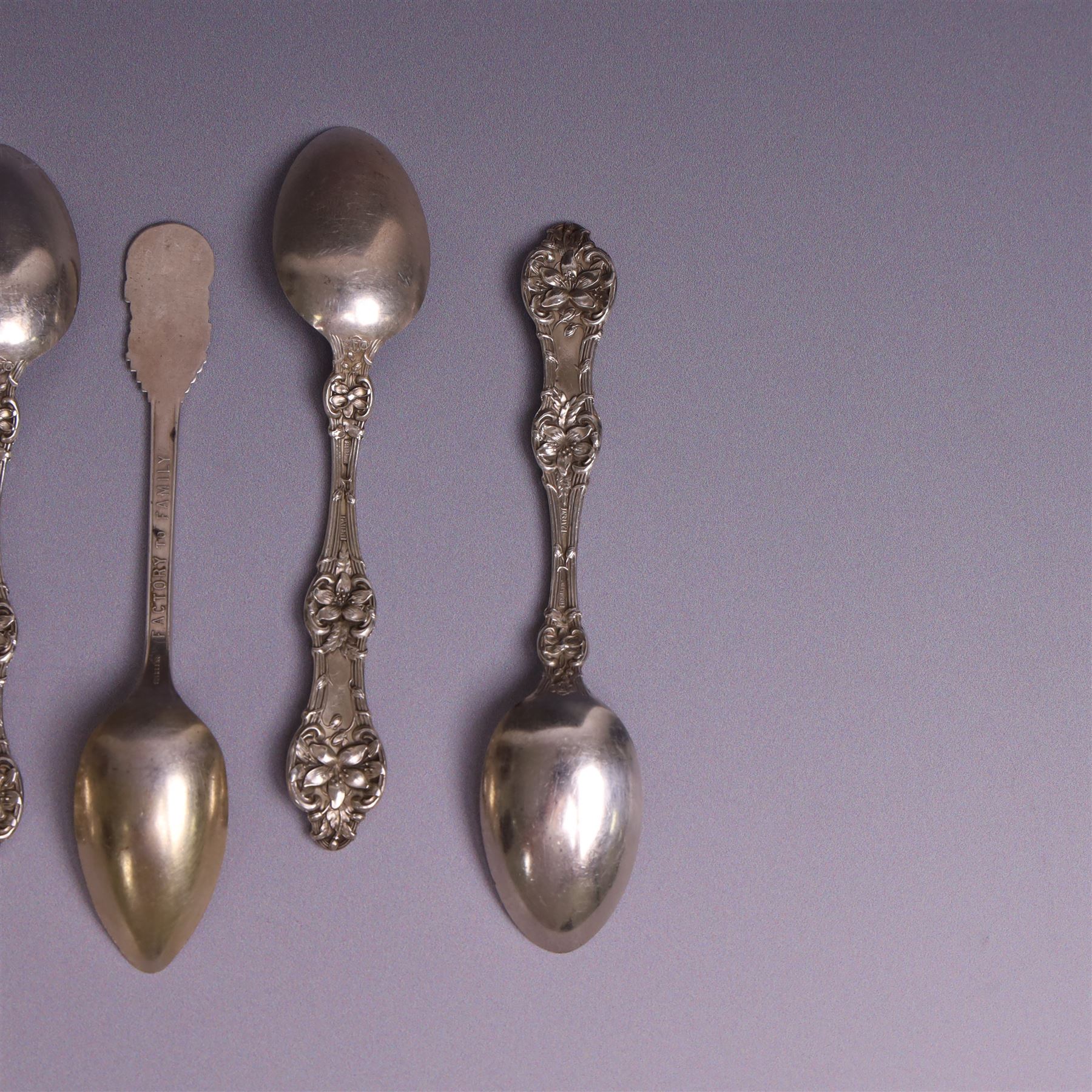 American silver tea and coffee spoons, comprising set of six coffee spoons with embossed lily decoration, set of six teaspoons with embossed rose decoration, both with engraved initials and a pair of Larkin coffee spoons, all stamped Sterling