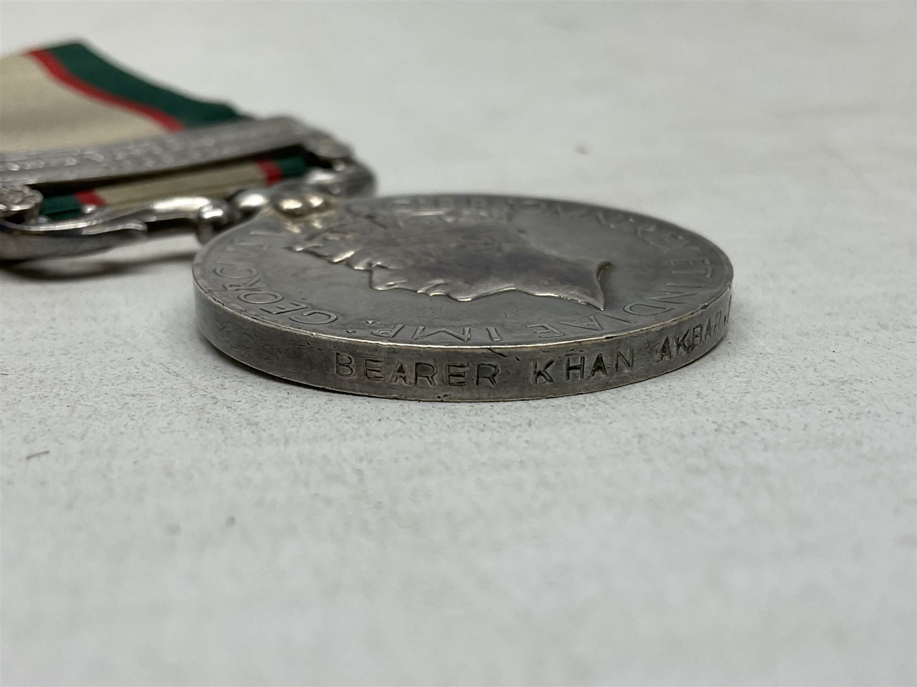 George VI India General Service Medal with North West Frontier 1936-37 clasp awarded to Bearer Khan Akbar 2-Border R.; with ribbon