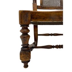 Late 19th century walnut hall chair, arched and scrolled crest rail over turned uprights, bergere seat and back panels, and raised on turned front supports with 'H' stretcher 