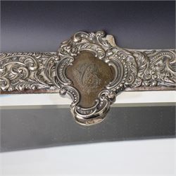 Late Victorian silver mounted dressing table mirror, the frame decorated with scrolls and oval cartouche initialled 'C', bevelled plate on an easel stand 57cm x 38cm London 1899 Maker Charles Henry Dumenil 