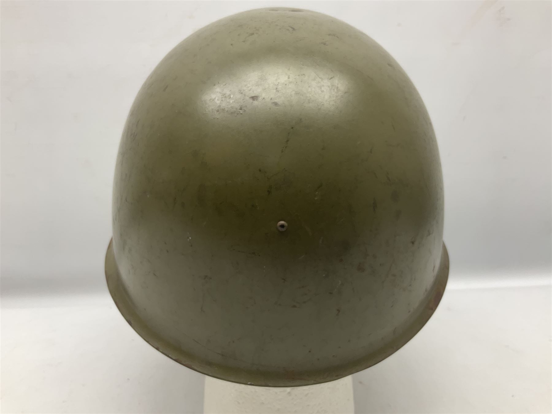 Two 1960s East Block Soviet style helmets - Czechoslovakian and Russian; both with liners (2)