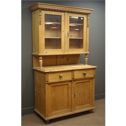  Late 19th century pine kitchen dresser, projecting cornice, two glazed doors enclosing three shelves, above two drawers and two cupboards, W109cm, H189cm, D54cm  