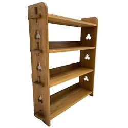 Mid-20th century light oak open bookcase, fitted with four pegged shelves, shaped end supports pierced with clubs
