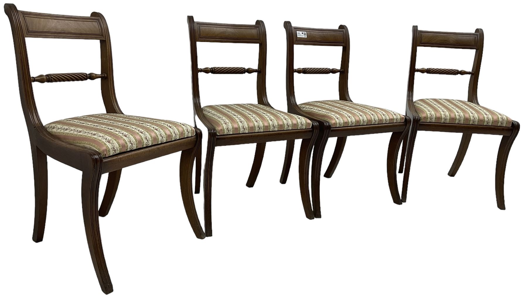 Set of four Regency period mahogany dining chairs, rope-twist centre back bar over pink and ivory floral patterned drop-in seats, on reed moulded sabre supports