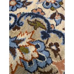 Central Persian Najafabad hand-knotted carpet, the ivory field with a central floral medallion radiating palmettes and arabesques in tones of blue, lilac and tan, enclosed by a wide navy border of scrolling vine and rosette motifs, with red spandrels and multiple guard stripes