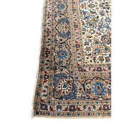Persian Kashan ivory ground carpet, the interlaced foliate medallion surrounded by trailing plant motifs interlaced with scrolls, the guarded border with repeating stylised flower heads