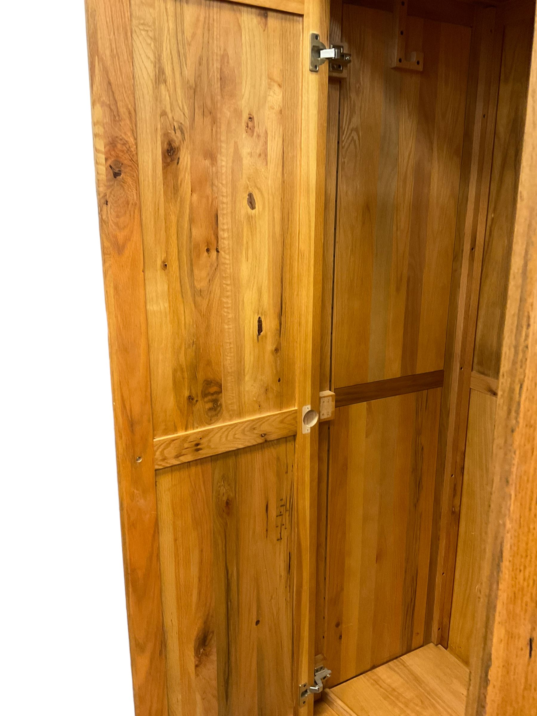 Oak double wardrobe, fitted with two panelled doors enclosing hanging