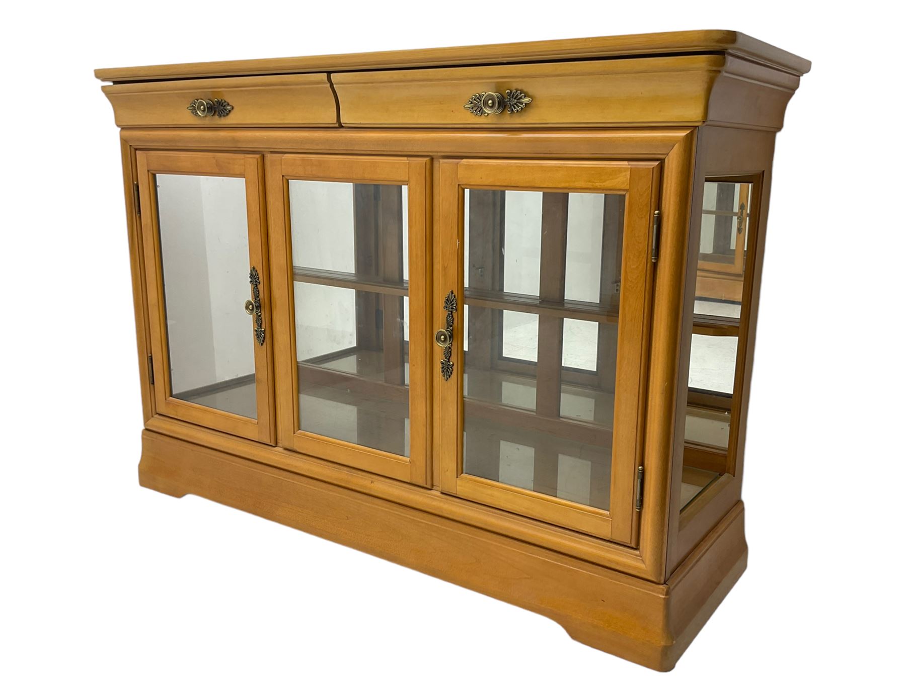 Yew wood sideboard, rectangular top with mahogany and ebony stringing, fitted with two drawers over three glazed cupboard doors enclosing glass shelves