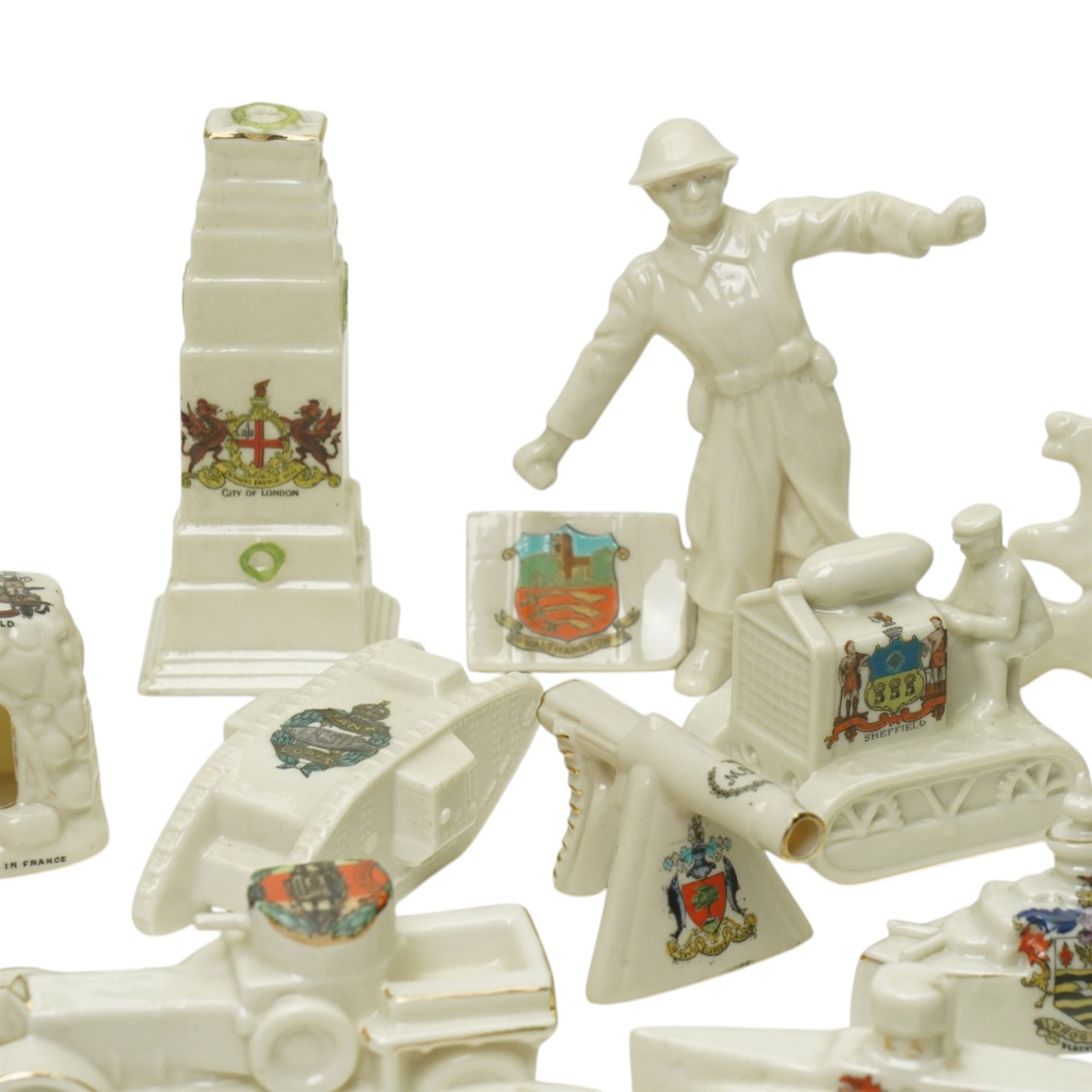 WW1 crested china including Grafton 'The Bomb thrower', Swan 'Nurse & Wounded Tommy', Model of Motor Tractor used on Western Front', two tanks, ambulance, Cenotaph etc