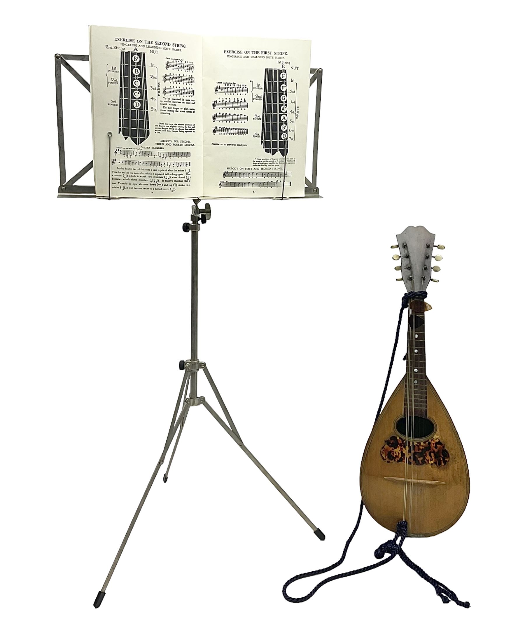 Late 19th/early 20th century Italian lute back mandolin with segmented back and spruce top; bears maker's label for Pietro Tonelli Napoli; together with a mandolin instruction booklet and a folding music stand L60.5cm
