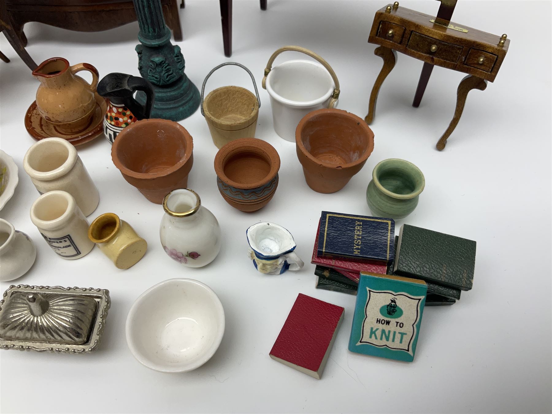 Collection of miniature dolls house furniture and accessories, to include long case clock, chest of drawers, tiled wash stand, ceramics and glass ware, mirror, baskets, etc 