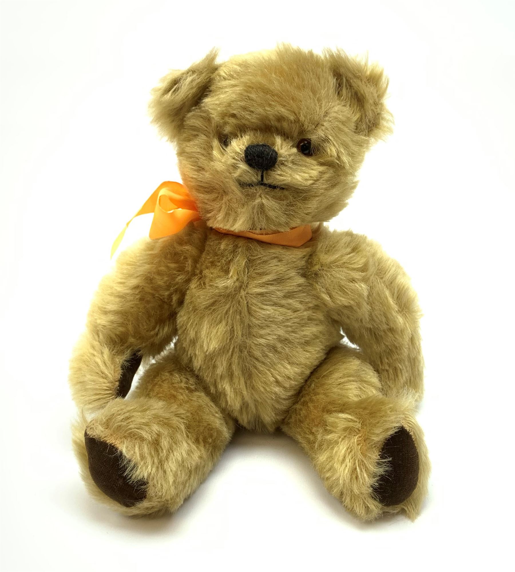 Chad Valley Hygienic Toys teddy bear c1950, kapok filled mohair plush body with original factory given yellow neck ribbon, jointed limbs with velvet paw pads, glass eyes and vertically stitched nose and mouth, blue/white printed label to side seam H12