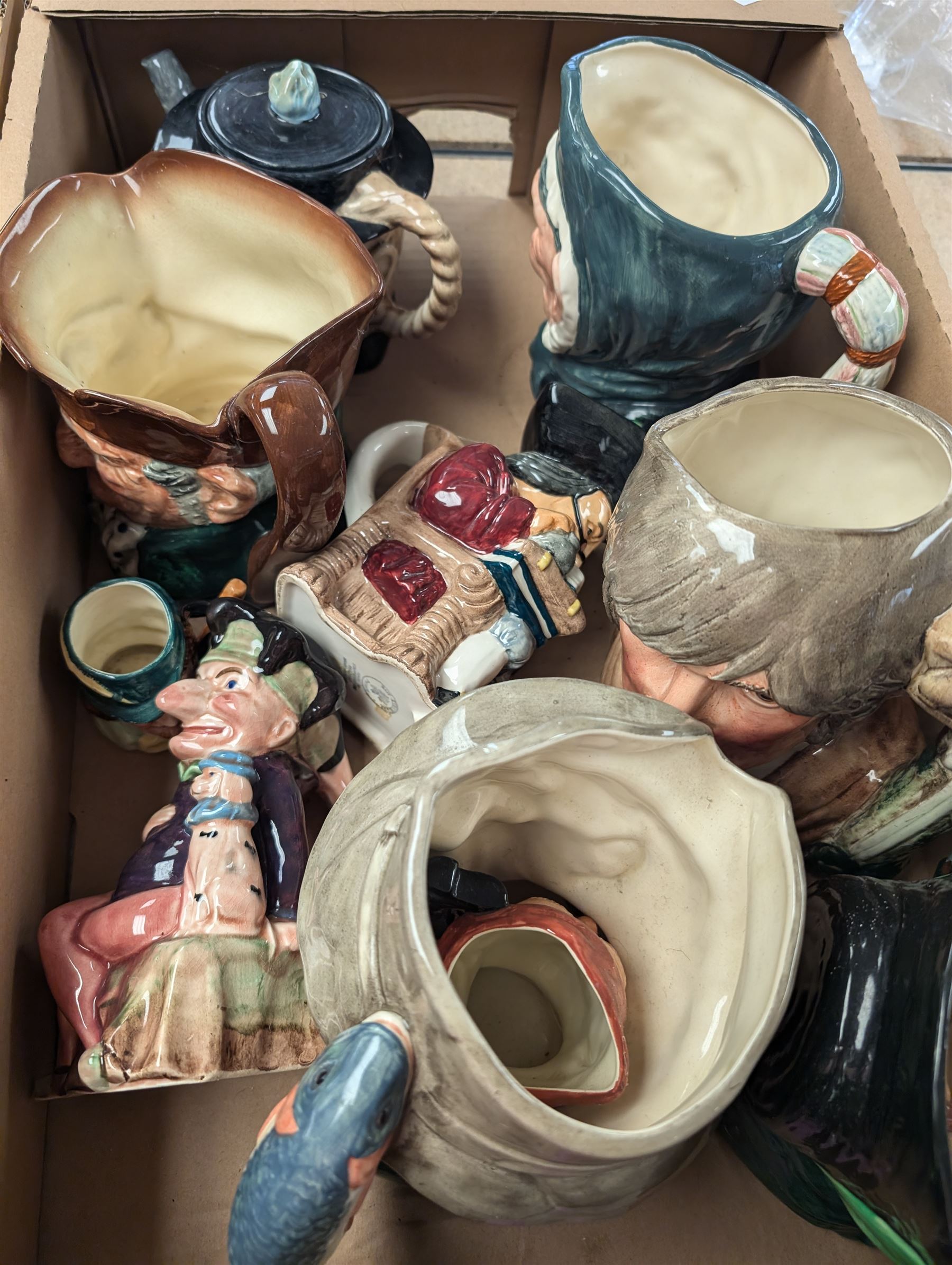 Collection of character and toby jugs and teapots, mostly Royal Doulton examples, in three boxes 