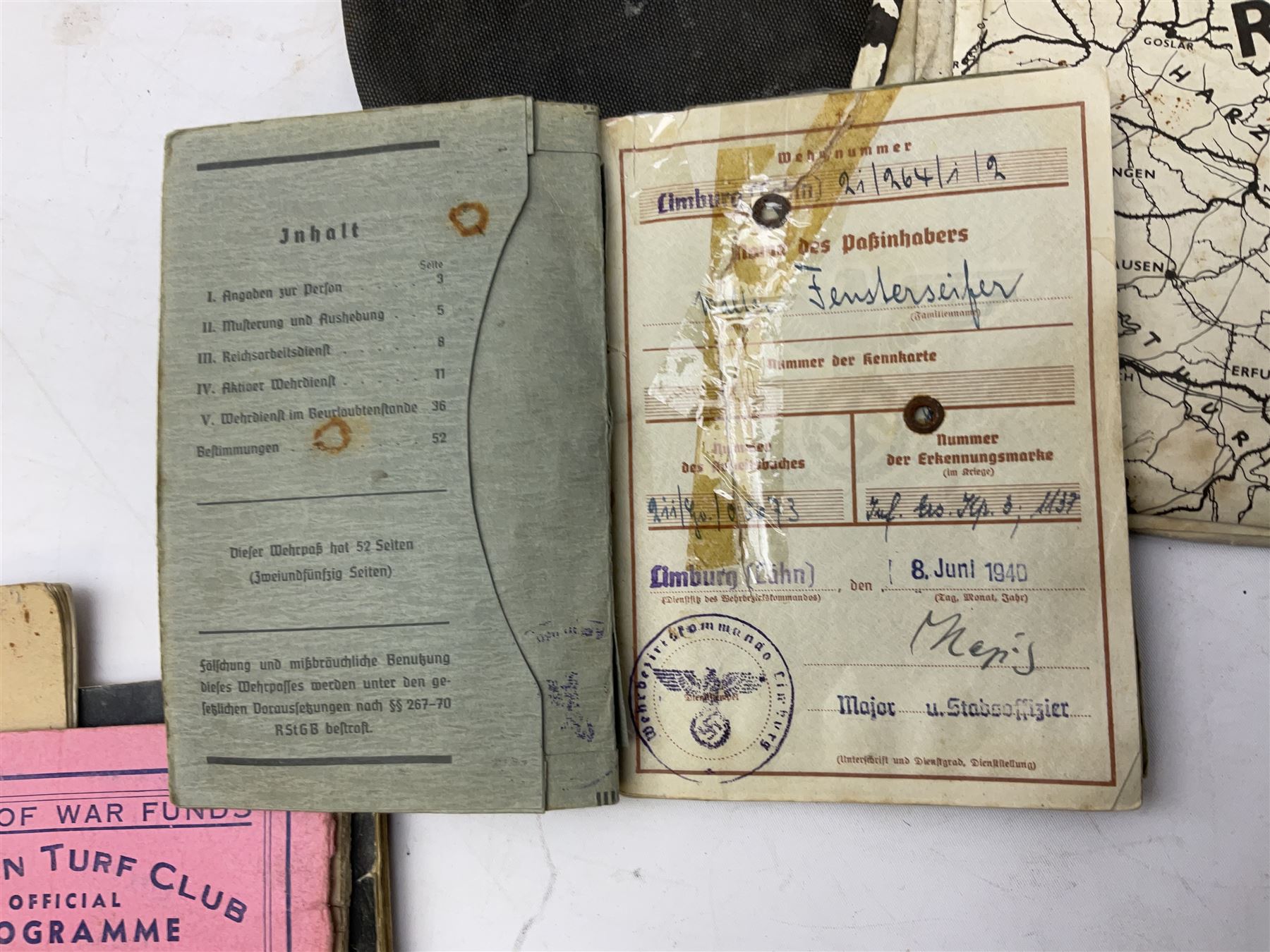 WW2 German War Pass (Wehrpass) identification paperwork for Walter Fensterseifer 2nd type booklet dated 8/6/1940, with signed photo of recipient in civilian suit. Born 31st January 1921. Numerous entries; together with quantity of small private photographs of German soldiers; One Million mark banknote 1923; 30th Corps in Germany booklet with Formation badge; and other WW2 paper ephemera