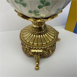 Franklin Mint The Emerald Isle Collector Egg, the egg decorated with embossed shamrocks upon a cream ground, with a gilded shamrock finial, accents and openwork door, opening to reveal a miniature landscape scene, upon three gilded feet set with green paste stones, with certificate of authenticity H23cm, 