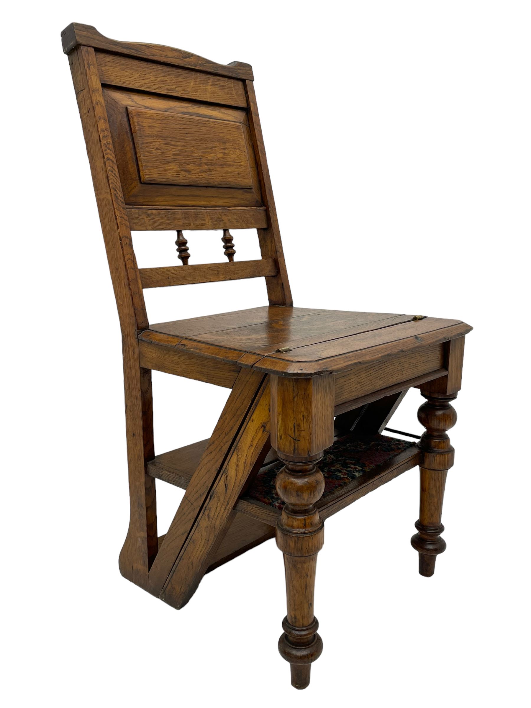 19th century oak metamorphic library steps and chair, panelled back with turned spindles over plank seat with turned front supports, the hinged seat folding forward, the steps inset with carpet treads  