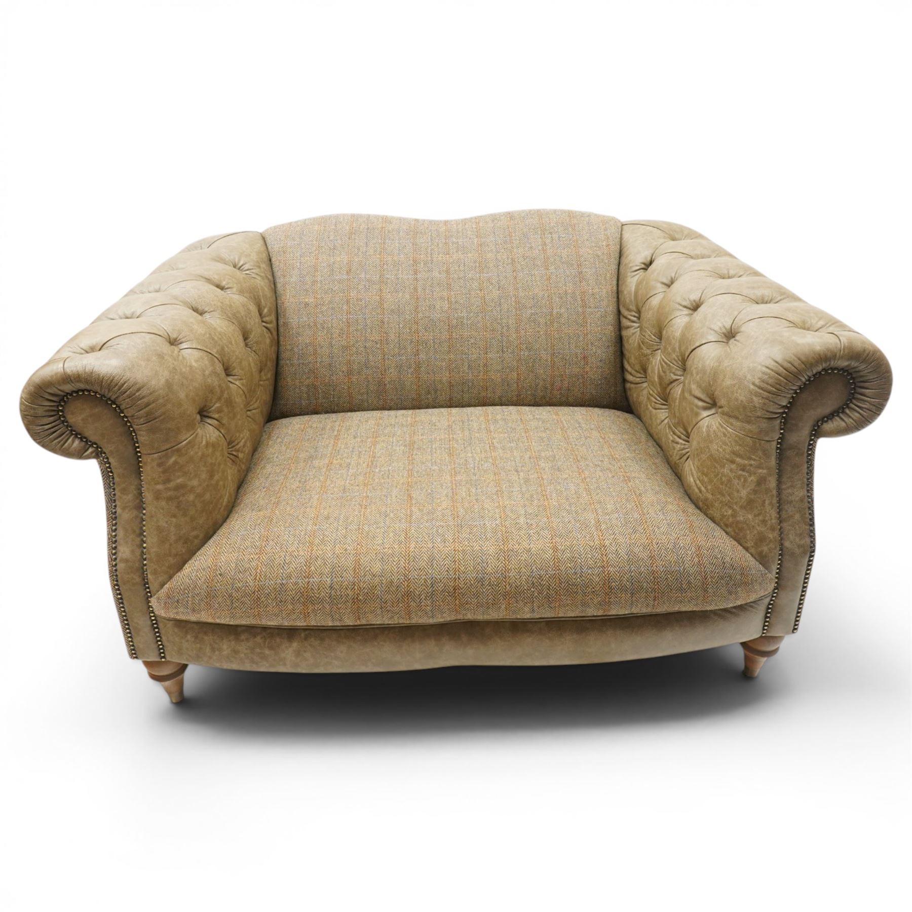 Tetrad - 'Matisse' snuggler armchair or loveseat, Chesterfield shape with rolled arms flanking a serpentine back and front, upholstered in herringbone pattern Harris Tweed and tan leather with close-nailed studwork, on turned feet