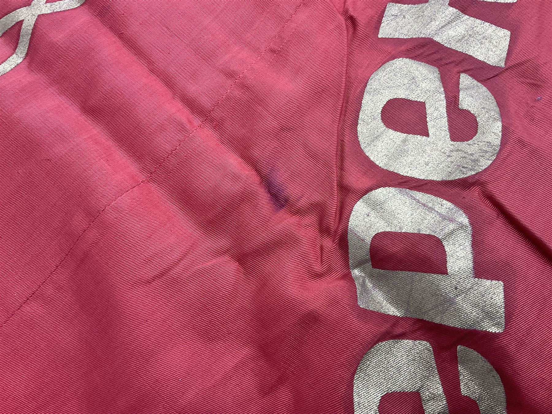 1970s Soviet banner printed in gold on a red ground, roughly translates as 'Transferable Banner - To the winner in the Socialist Competition' and 'Work Study Live by Communism' verso; wreath of wheat ears to either side; tassels on three sides 110 x 155cm