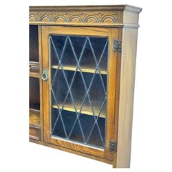 Large mid-20th-century oak dresser with two astragal glazed doors between gallery shelf and lower shelf, with three short drawers and lower section with four drawers and three double-panelled linen-fold hinged cupboard doors 