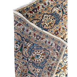 Persian Kashan ivory ground carpet, the interlaced foliate medallion surrounded by trailing plant motifs interlaced with scrolls, the guarded border with repeating stylised flower heads