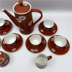 Noritake coffee set, decorated with white flowers upon a russet red ground, in one box 