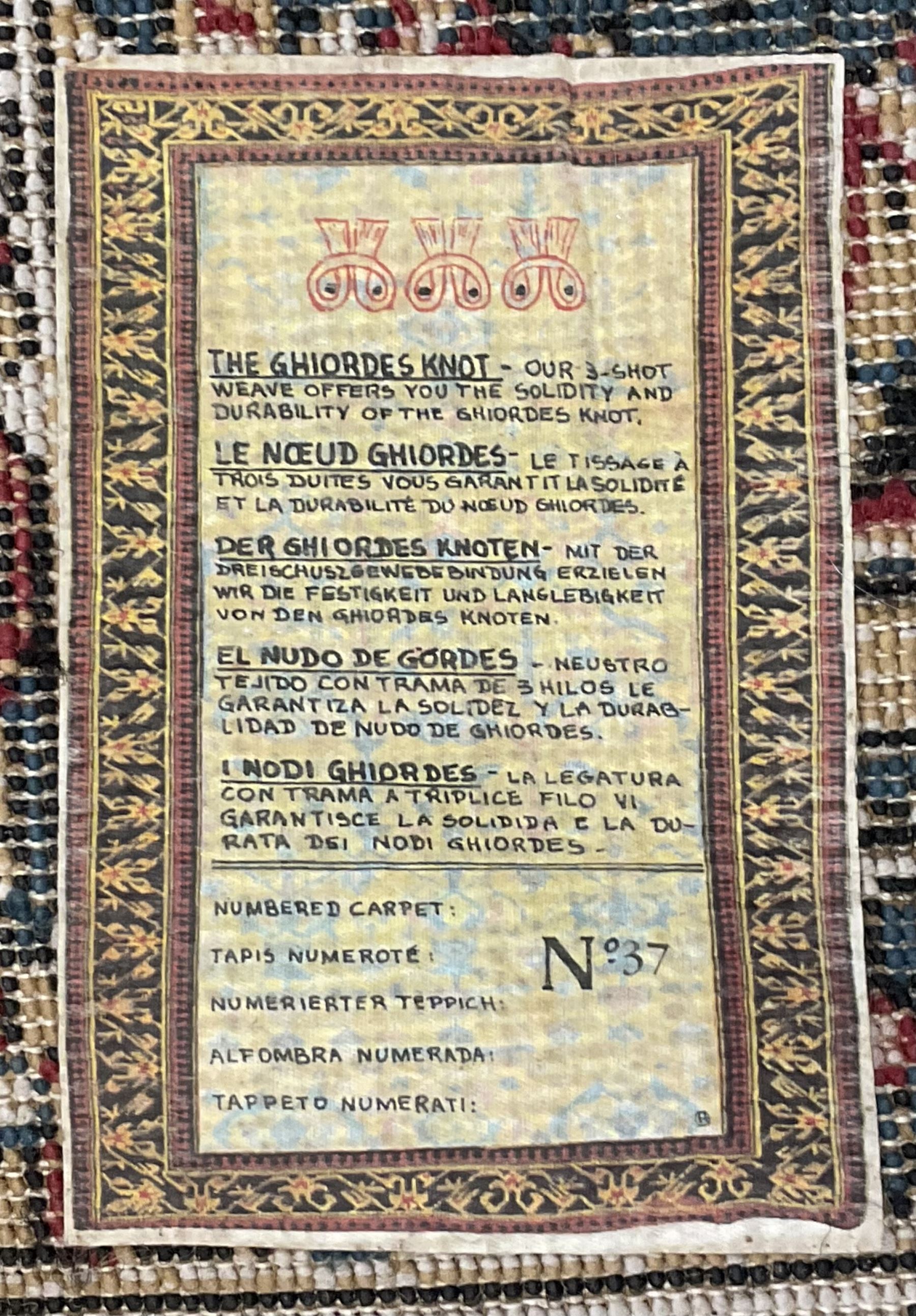 Persian design rug, rectangular crimson ground field with medallion, surrounded by trailing foliate branches, within wide border bands decorated with stylised floral motifs 