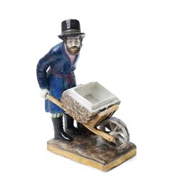 Russian, probably Gardner figure of a man pushing a wheelbarrow on gilt lined rectangular base, impressed mark, H16cm, 18th century creamware beaker with star shape decoration, 18rh century Worcester cup with panels of flowers on a blue ground and a French shell shape scent flask (4)