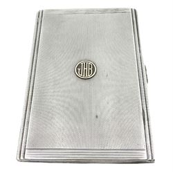 1930's silver cigarette case, with engine turned decoration and stepped border, the front with applied roundel containing initials 'JHB', hallmarked Wilson & Gill, Birmingham 1936, H12.5cm, approximate weight 5.94 ozt (185 grams)