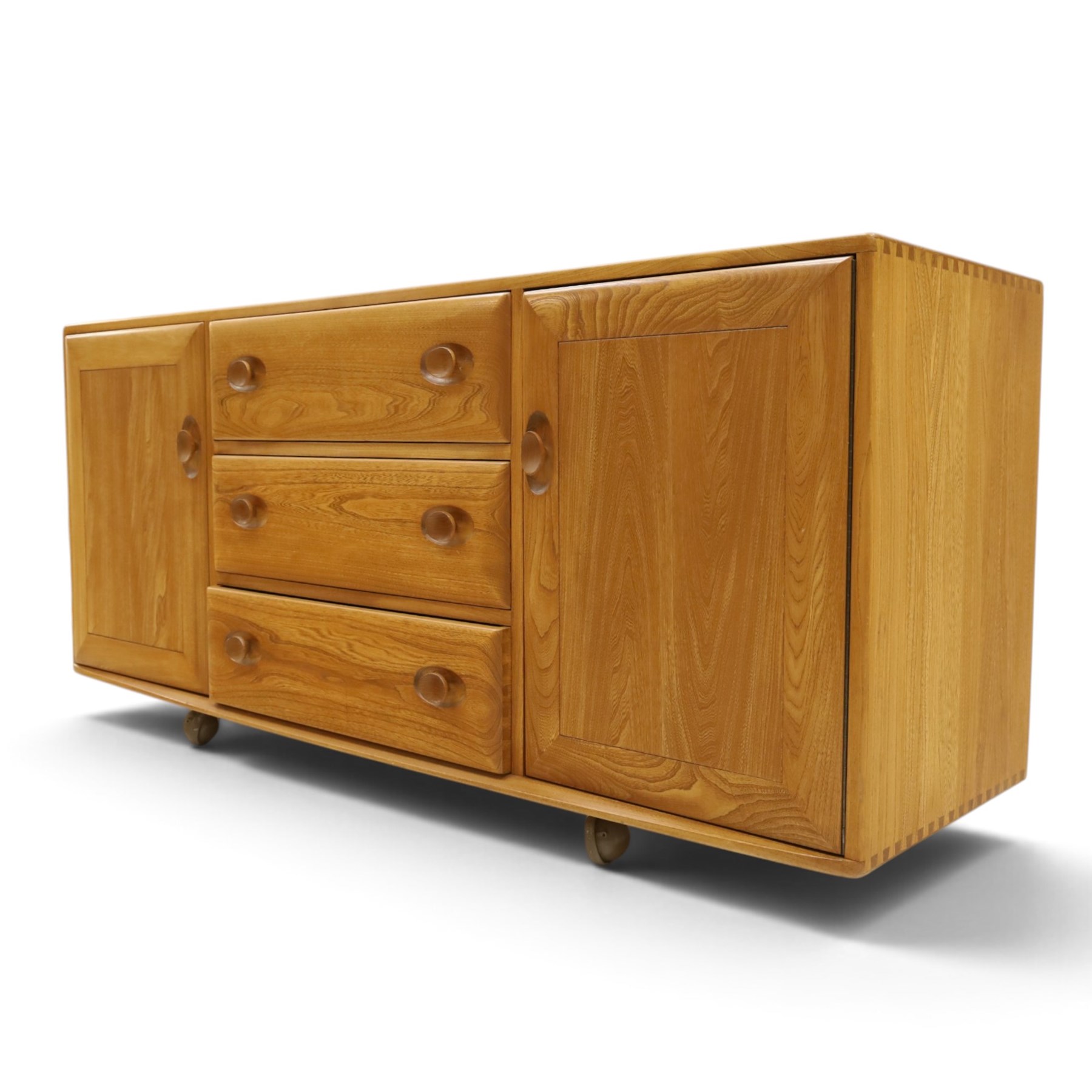 Ercol - mid-20th century light elm and beech Windsor 'model 455' sideboard, rectangular top over three central drawers flanked by cupboards, on castors
